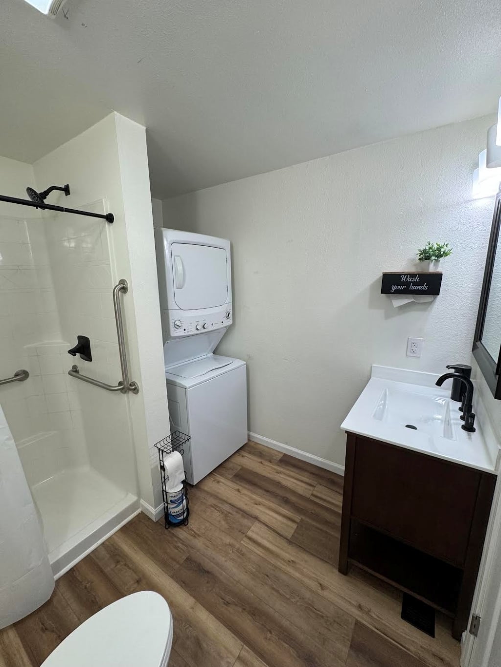 Shared bathroom with washer and dryer